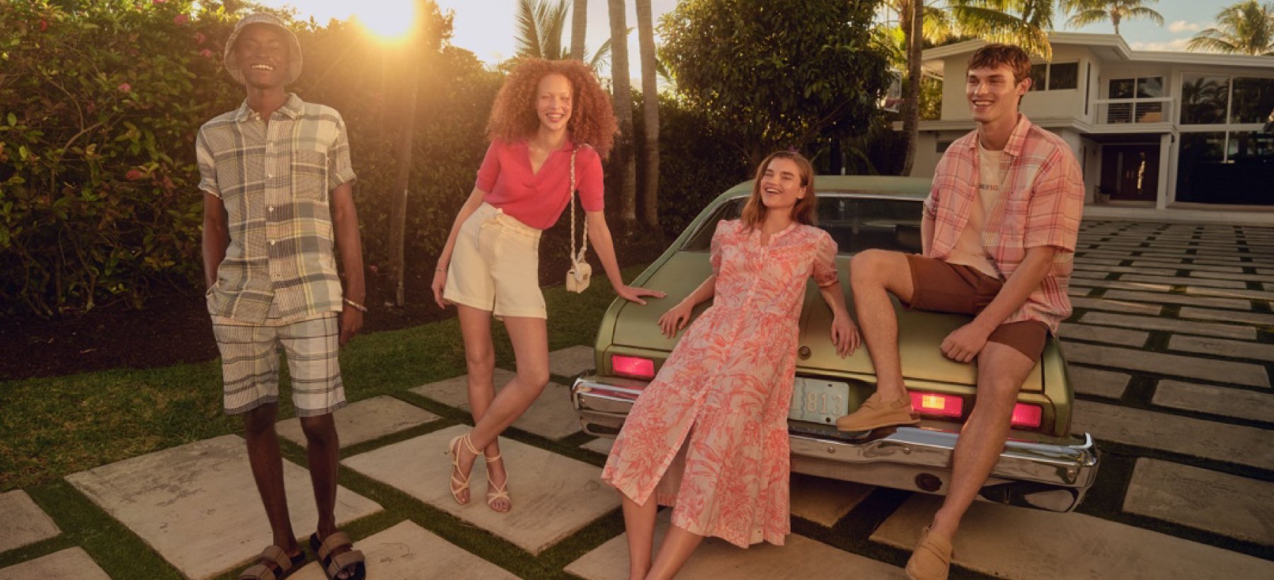 Two Men and Two Women Modelling Tommy Hilfiger Fashion in a Front Yard