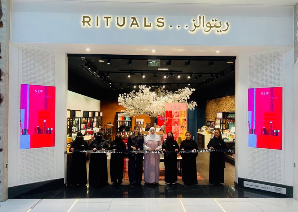 Eight Women Cutting the Tape in Front of Rituals Store