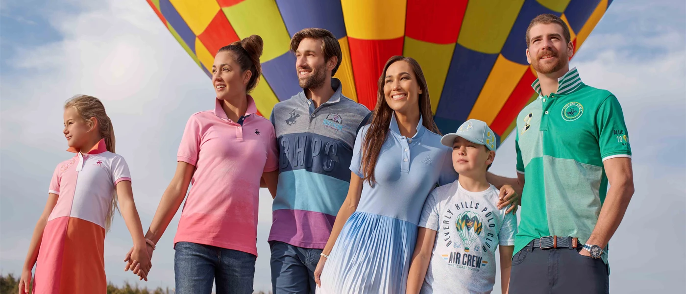 Male Female and Children Models Wearing Beverly Hills Polo Club Clothing in Front of Balloon