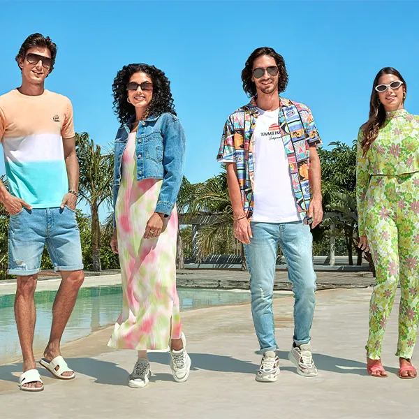 Two men and two women outside by the pool wearing R&B summer clothing